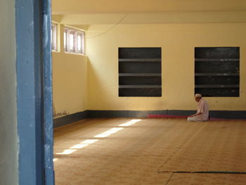 Full length of woman standing in illuminated room