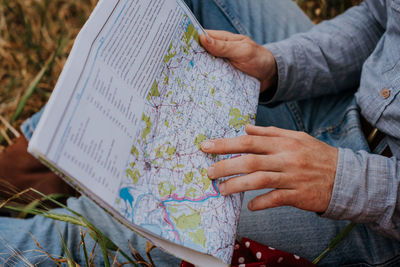 Close-up of hand holding book