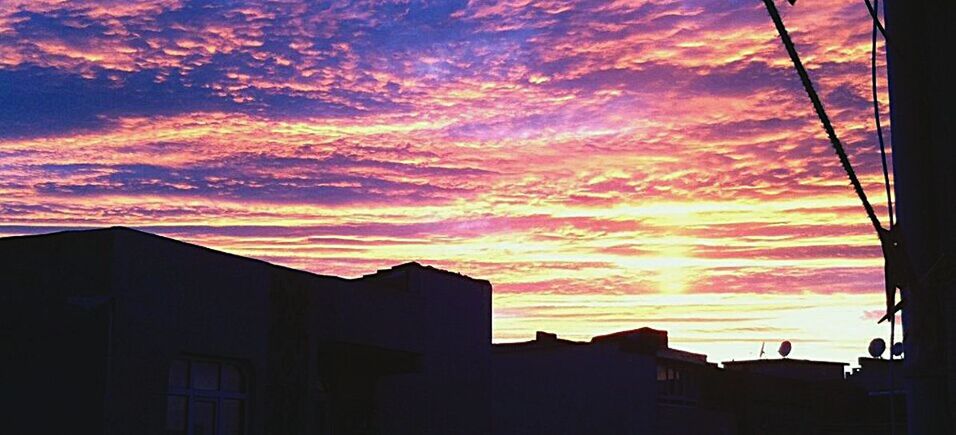 sky, building exterior, architecture, cloud - sky, built structure, sunset, building, silhouette, nature, orange color, no people, low angle view, sunlight, city, beauty in nature, outdoors, dramatic sky, residential district, dusk, house, romantic sky