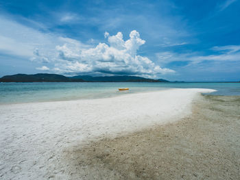 White sand beach island with kayak on a sandbank, mountain and cumulus cloud. koh mat sum, thailand.