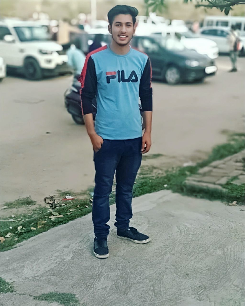 looking at camera, portrait, one person, car, full length, front view, motor vehicle, standing, real people, transportation, casual clothing, smiling, land vehicle, mode of transportation, day, city, focus on foreground, emotion, boys, teenager, teenage boys, adolescence