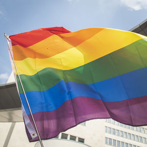 Low angle view of a rainbow flag against sky