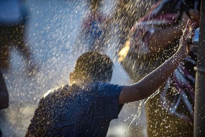 Close-up of boy outdoors during rainy season