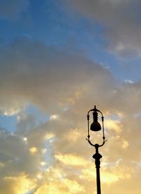 Low angle view of silhouette street light against sky