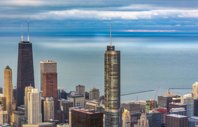 View of skyscrapers against cloudy sky