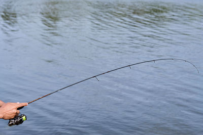 Low angle view of man fishing in water