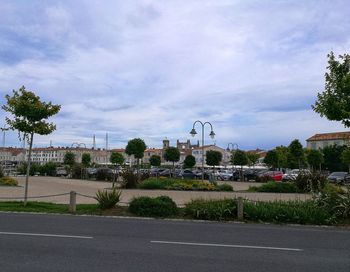 Road by city against sky