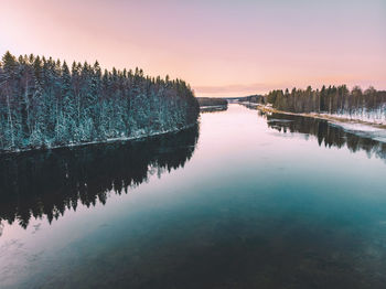 Scenic view of lake against sky at sunset