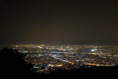 High angle view of illuminated buildings against sky at night