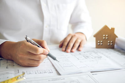 Midsection of man working on table