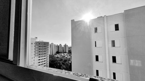 Buildings against sky on sunny day