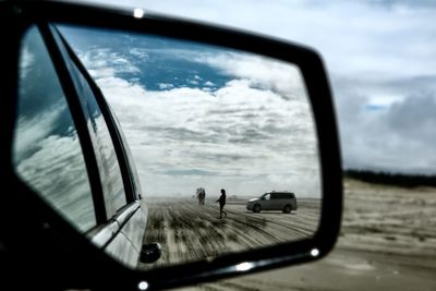 Reflection of sky on side-view mirror