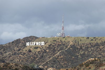 View of communications tower against cloudy sky