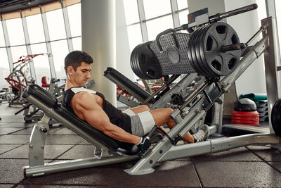 Midsection of man exercising in gym