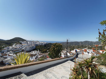 Panoramic shot of buildings against clear blue sky