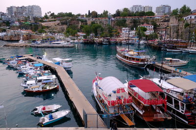 High angle view of boats moored at harbor in city