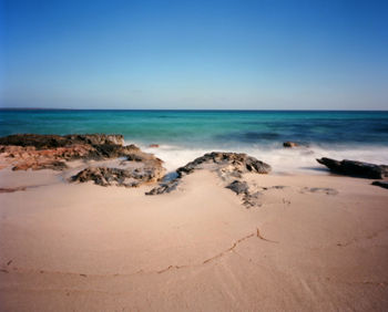 Scenic view of sea against clear blue sky