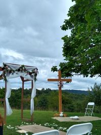 View of cross on field against sky