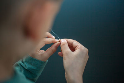 Midsection of boy preparing fishing bait