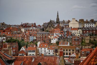 Buildings in city against sky