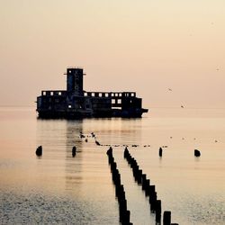Scenic view of sea against clear sky during sunset