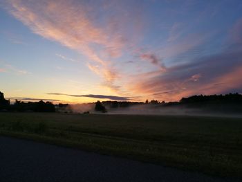 Scenic view of field against sky during sunset