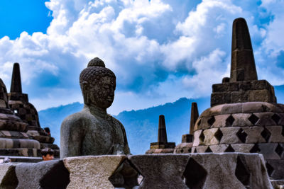 Statue of temple against building