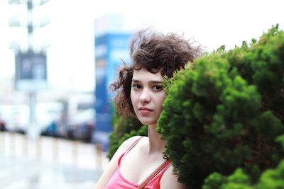 Portrait of young woman against blurred background