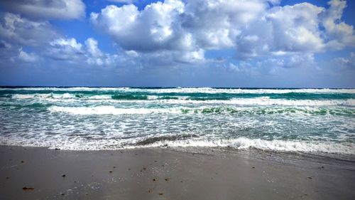 Scenic view of sea against cloudy sky