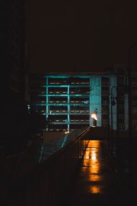 Man in illuminated building at night