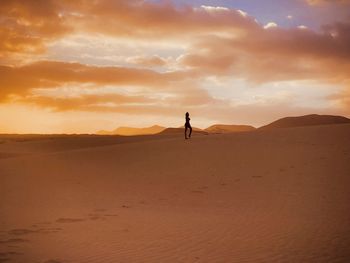  scenic view of desert against sky during sunset
