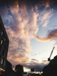 Low angle view of silhouette buildings against sky during sunset