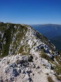 Scenic view of rocky mountains against clear blue sky