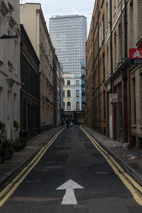 Road amidst buildings in city