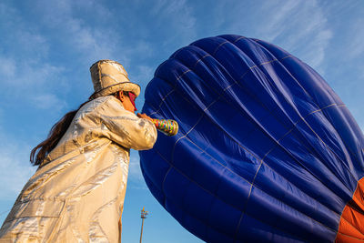 Low angle view of statue against blue sky