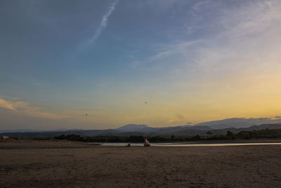 Scenic view of beach against sky during sunset