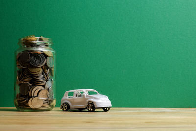 Toy car on table against green background
