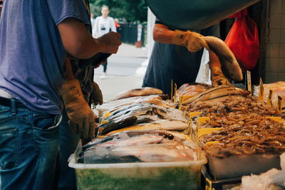 Midsection of people at fish market