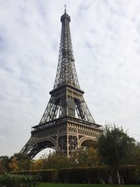 Low angle view of eiffel tower against cloudy sky