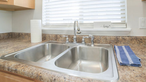 Close-up of faucet in bathroom at home