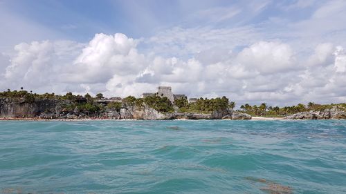 Panoramic view of tulum from sea against sky