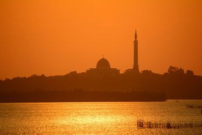 Silhouette of building against sky during sunset