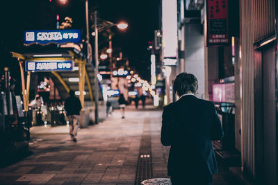 Woman in city at night