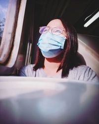 Portrait of a young woman sitting in car