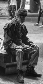 Midsection of man sitting outdoors