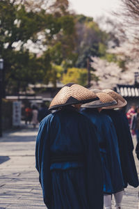 Rear view of man walking on footpath