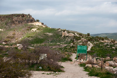 Road leading towards mountain against sky