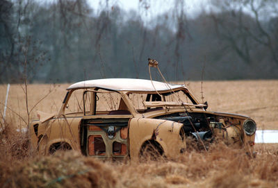 Abandoned car on field