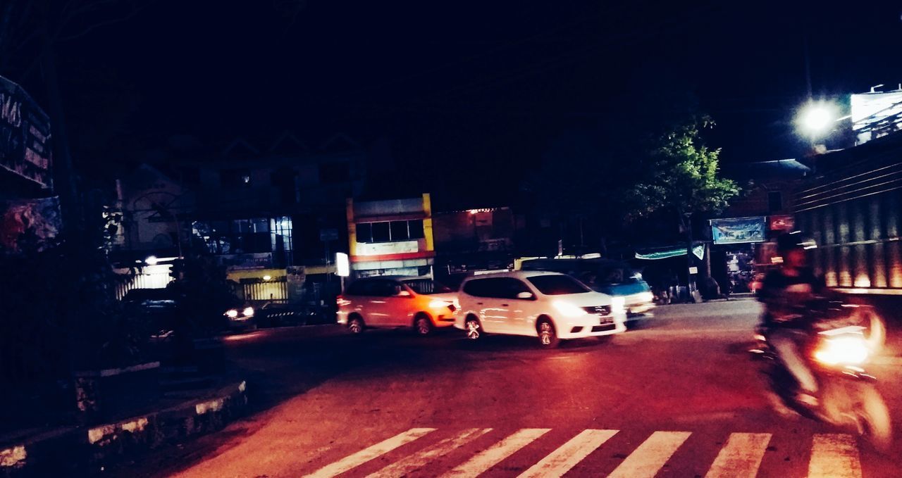 CARS ON CITY STREET AT NIGHT
