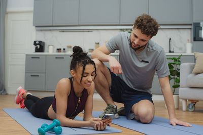 Side view of young man exercising at home